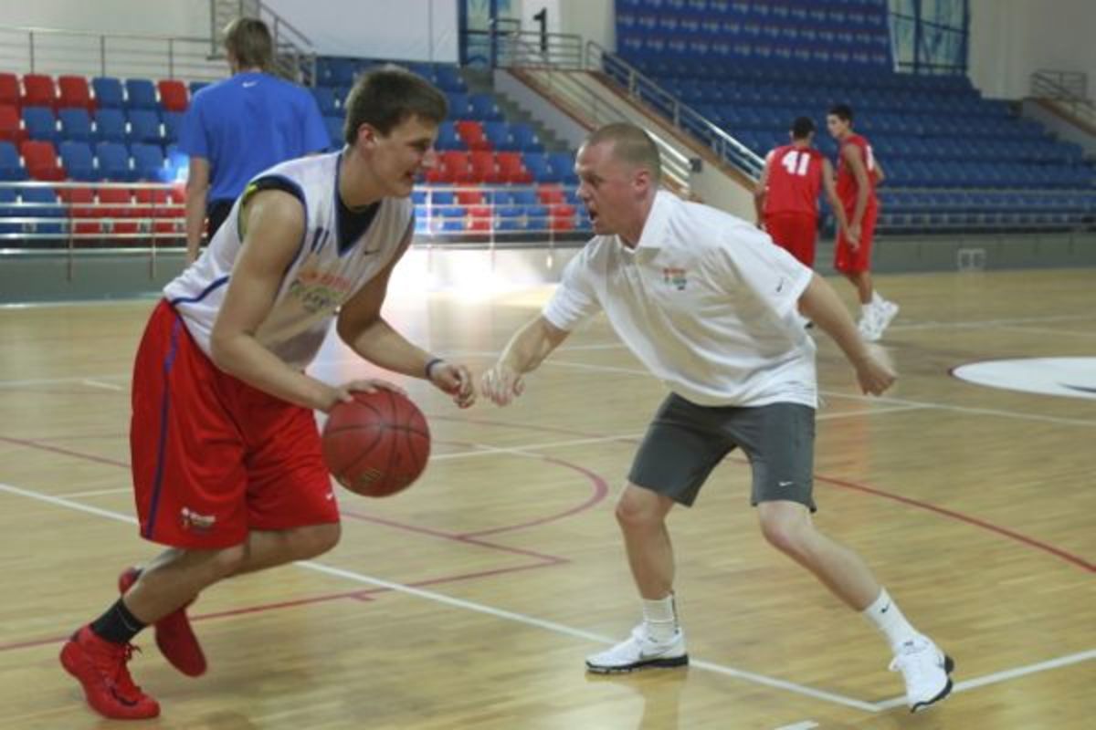 New Nuggets GM Tim Connelly (right) puts a Russian player through a workout. (Catherine Steenkeste/Getty Images)