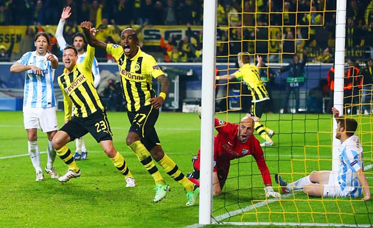 Borussia Dortmund celebrates Felipe Santana's (center) deciding goal to beat Malaga.