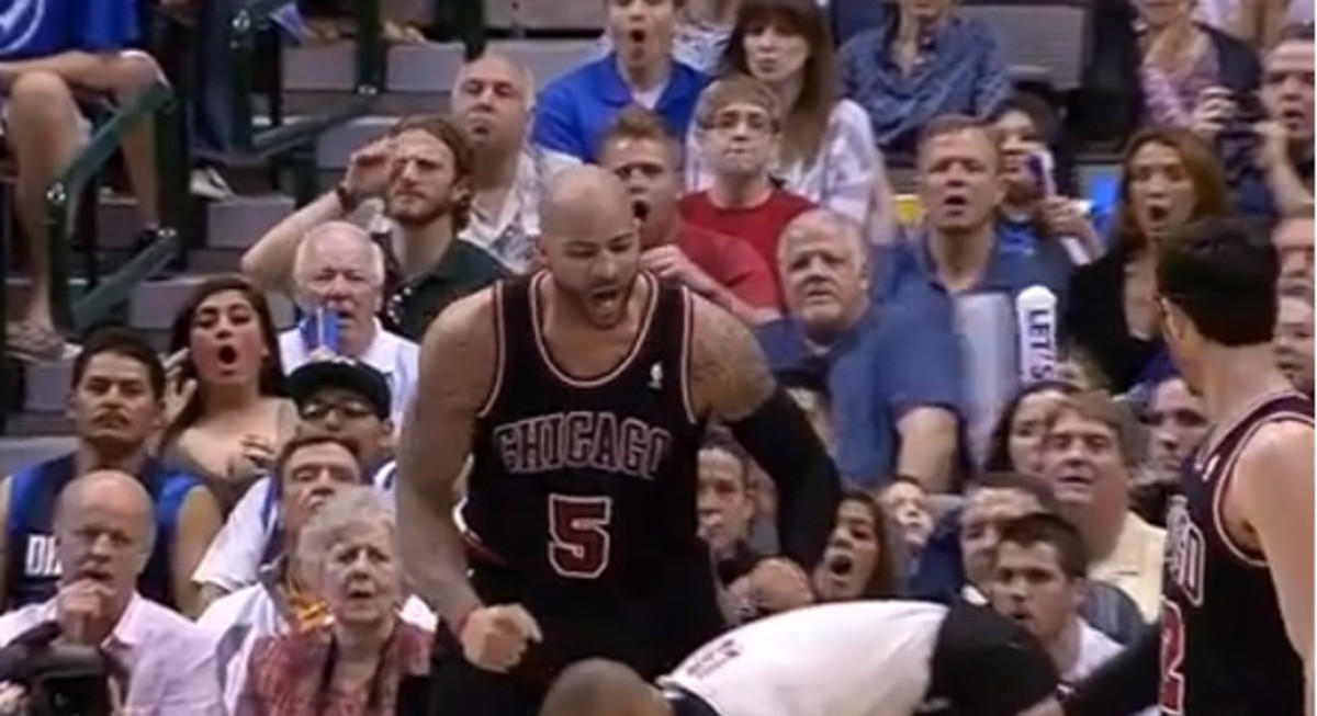 Carlos Boozer doubles over referee Danny Crawford with a celebration.