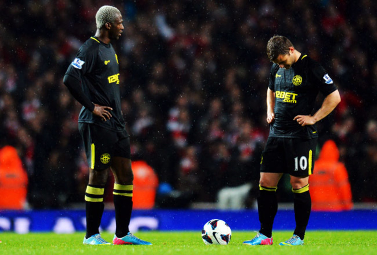 Shaun Maloney (right) looks down in dejection after falling behind to Arsenal in the second half.
