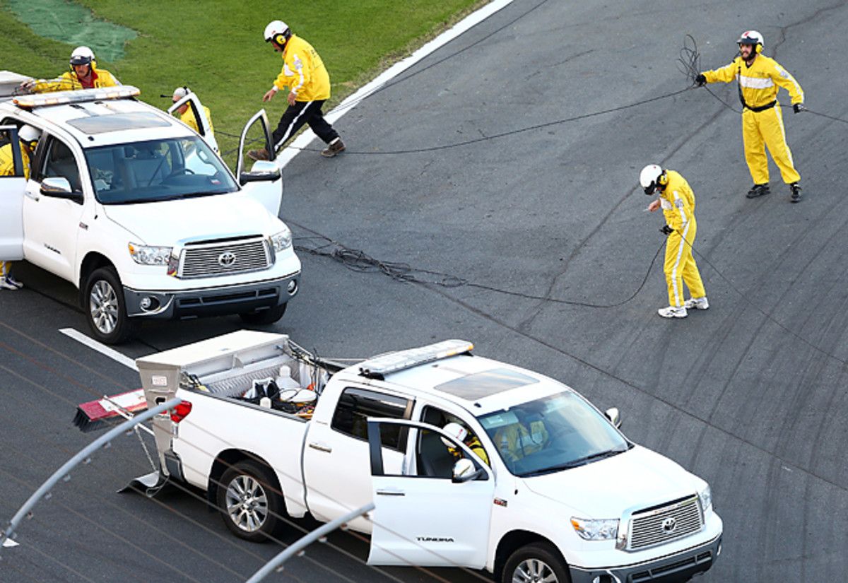 Track workers cleaned up a TV cable that landed on the track at Charlotte, causing a delay in the race.