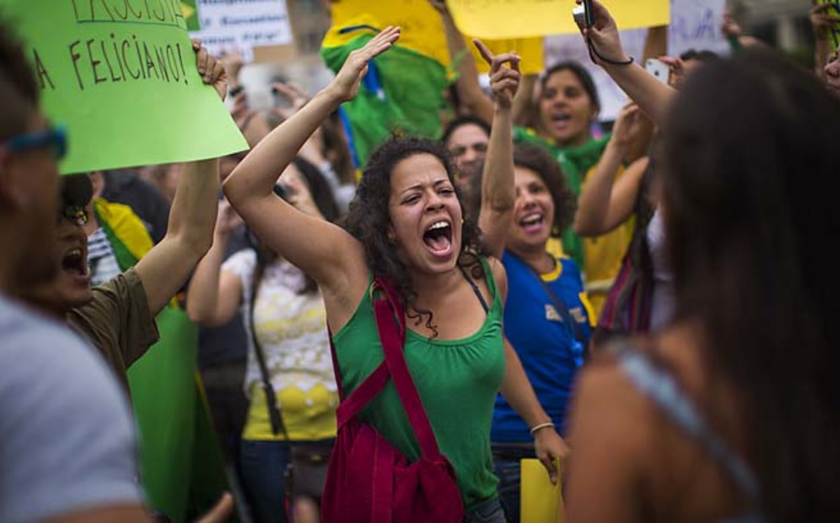 Brazilian protesters shout slogans against the Brazilian government during a demonstration in Barcelona, Spain, on Tuesday.