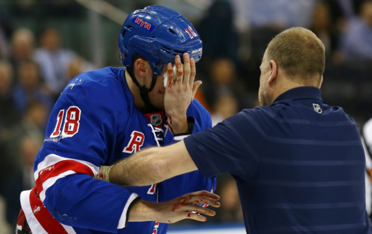 The NHL is discussing mandatory visor usage to mitigate against injuries to the face, like the one suffered by the Rangers' Marc Staal (above) in March. (Elsa/Getty Images)