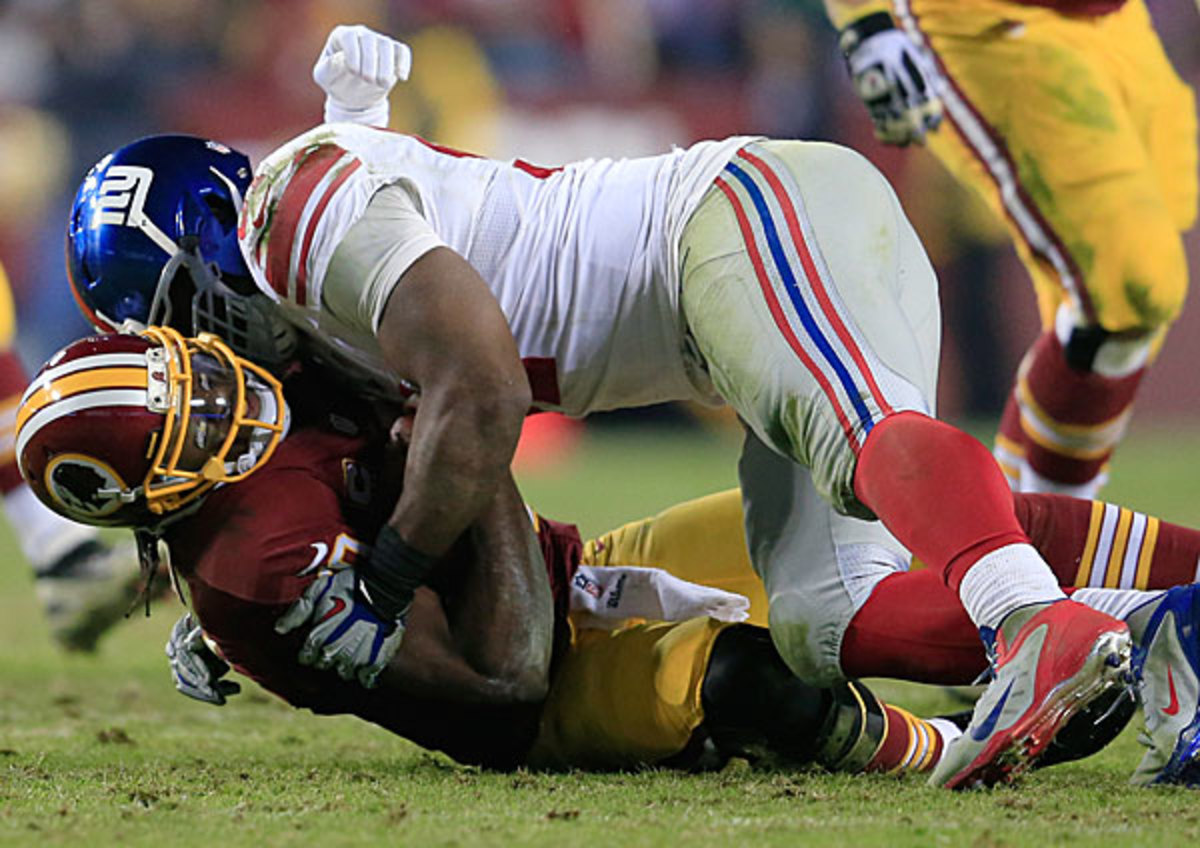Justin Tuck (top) spent the night in the Washington backfield, tallying four sacks. 
