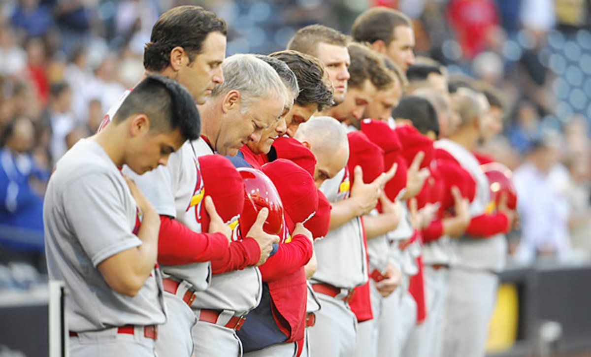 St. Louis Cardinals players and staff observed a moment of silence before playing the San Diego Padres.