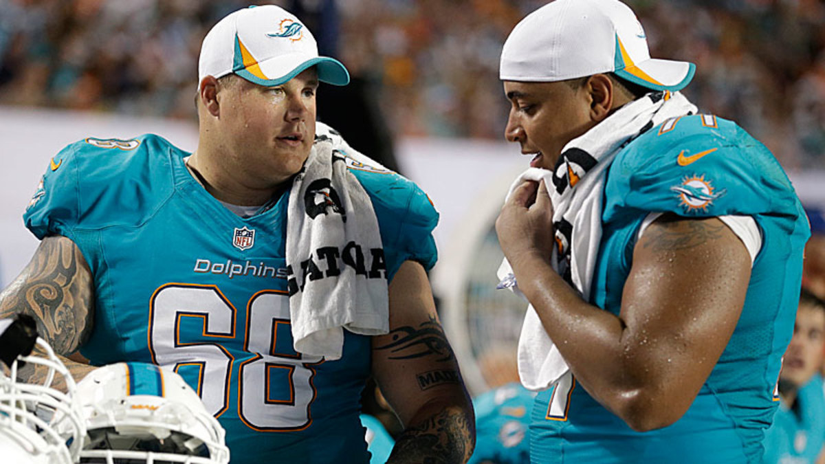 The Dolphins are down two starting offensive linemen after Richie Incognito's (left) was suspended for alleged hazing of Jonathan Martin, causing Martin to walk out on the team. (Wilfredo Lee/AP)