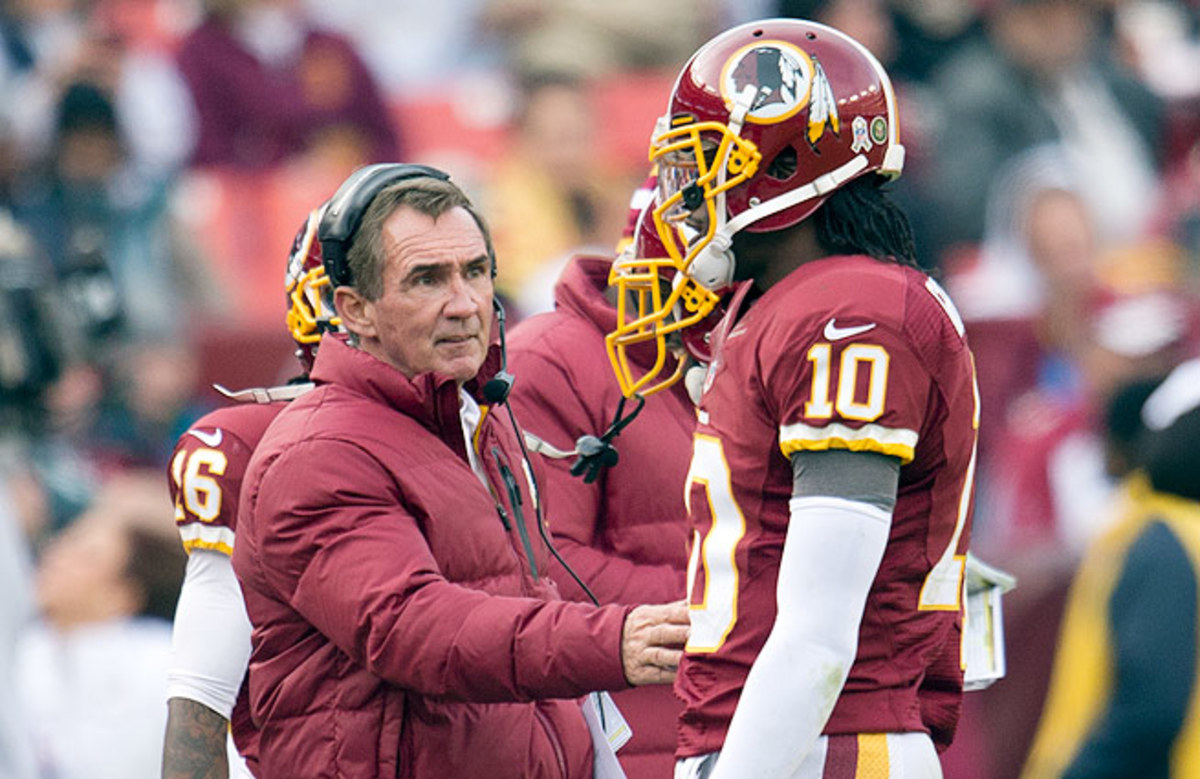 Tension mounted between Mike Shanahan (left) and Robert Griffin III all year, culminating in RGIII's benching.