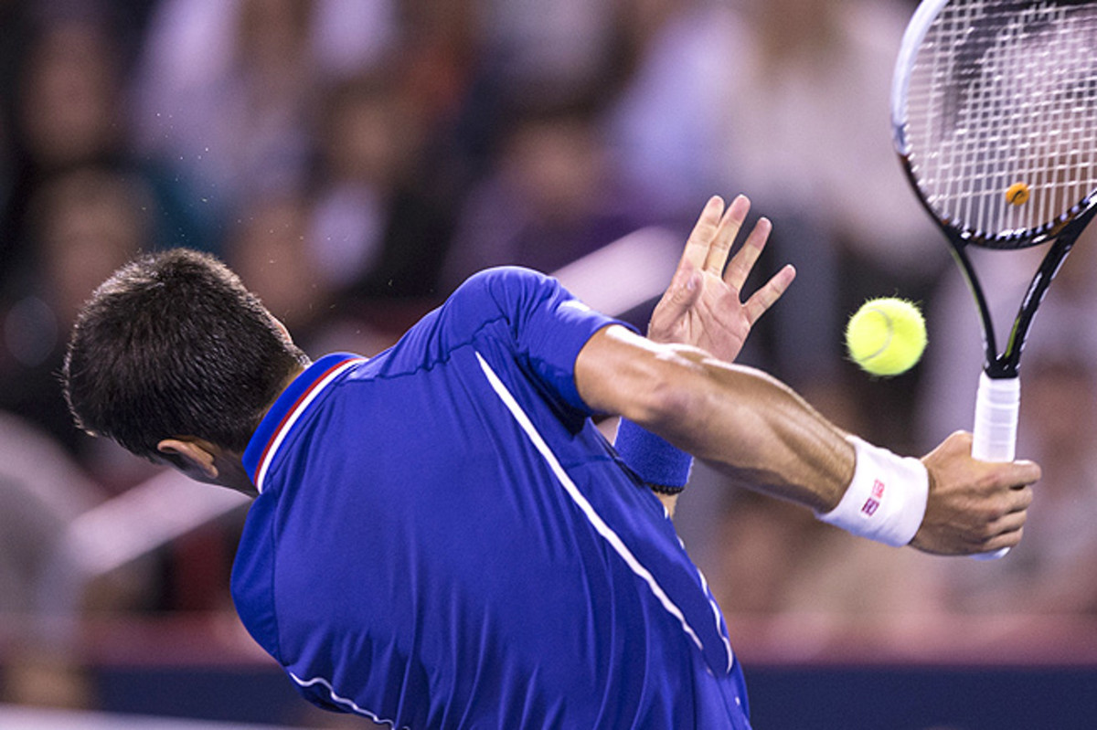 Novak Djokovic recoils after being hit in the chin by Rafael Nadal's shot in the Rogers Cup semifinals.