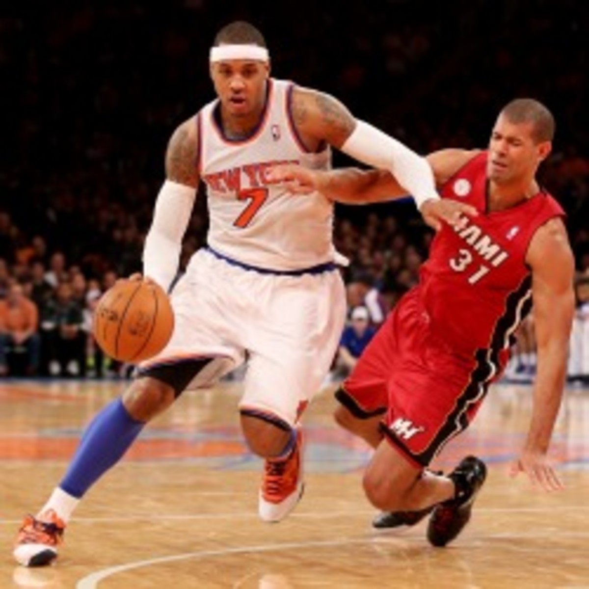 Carmelo Anthony #7 of the New York Knicks drives past a falling Shane Battier #31. (Photo by Nick Laham/Getty Images)