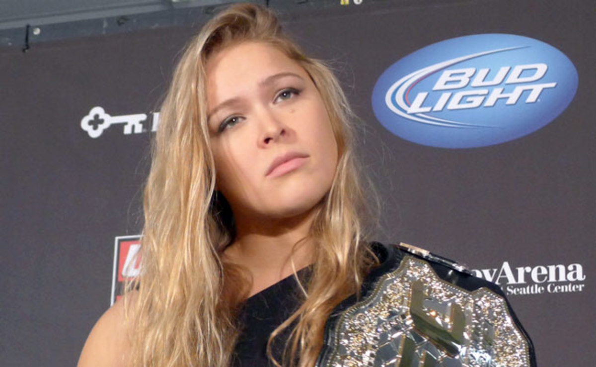 All three of SI.com's experts predict that Ronda Rousey will defeat Liz Carmouche by submission. (AP)