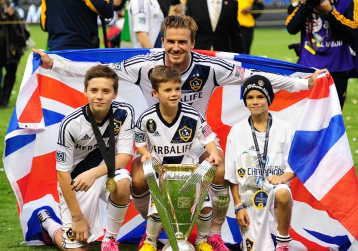 David Beckham supports his sons, (L-R) Brooklyn, Cruz and Romeo, following in his footsteps. (Robyn Beck/Getty Images)