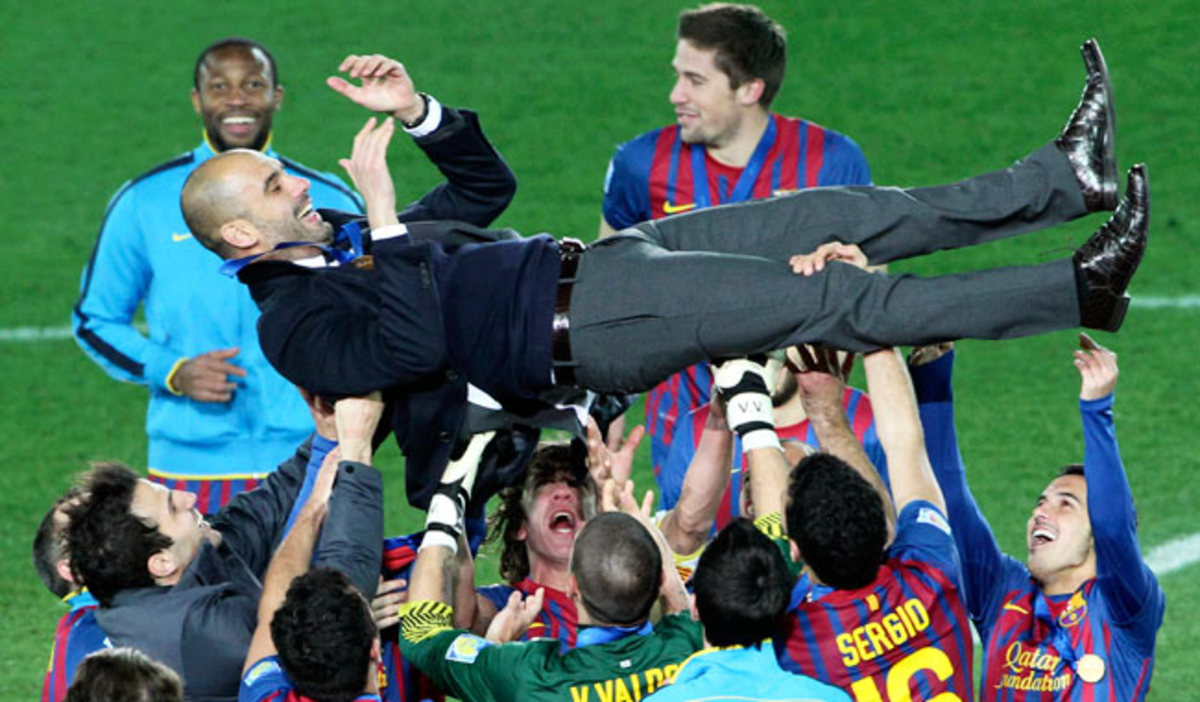 Barcelona players lift their manager Pep Guardiola after winning the Club World Cup in Dec. 2011.