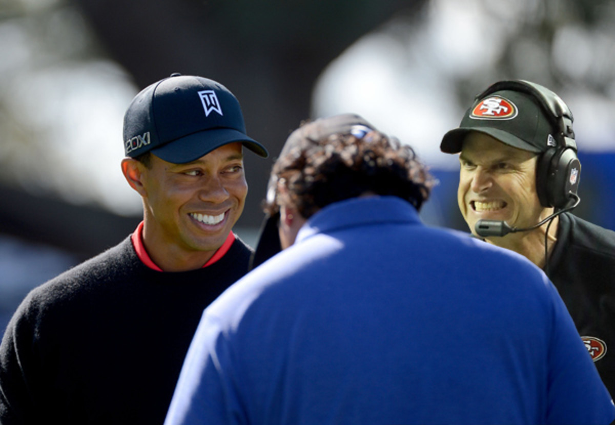 Tiger Woods stares at Jim Harbuagh