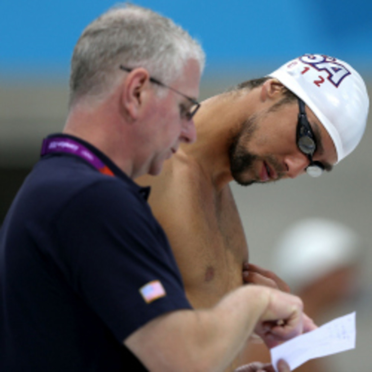 Bob Bowman speaks with Michael Phelps during a training session. Bowman will be advising Turkey on its swim program as a consultant. (Clive Rose/Getty Images)