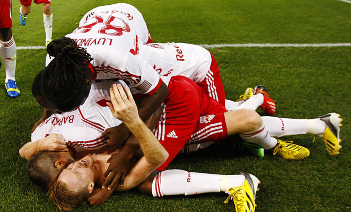 Dax McCarty is mobbed by Red Bulls teammates after scoring a stoppage-time winner against RSL.