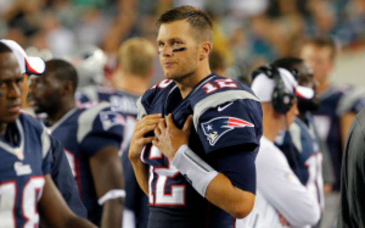 Patriots quarterback Tom Brady limped off the practice field on Wednesday with a reported knee injury. (Hunter Martin/Getty Images)