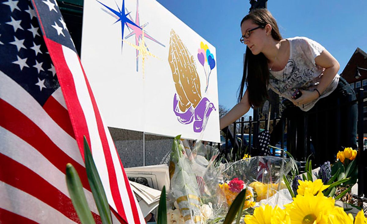 Shannon Walsh, 15, puts flowers on a memorial to Boston Marathon bombing victim Martin Richard, 8.