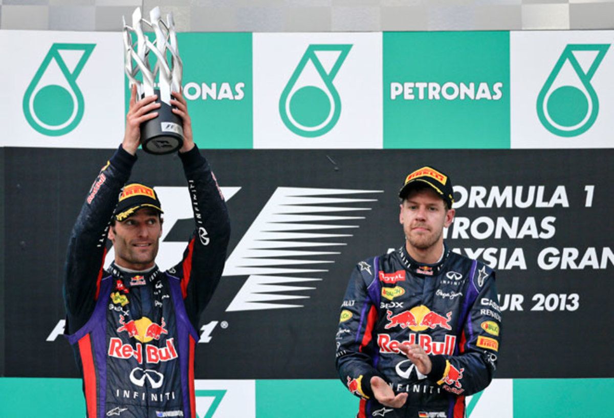 Mark Webber (left) had to accept the runner-up trophy after being passed by Sebastian Vettel (right).
