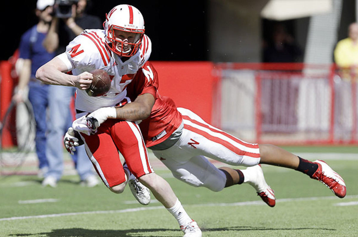 Linebacker Thomas Brown sacks Ryker Fyfe (left) during the annual Nebraska Red-White spring game.
