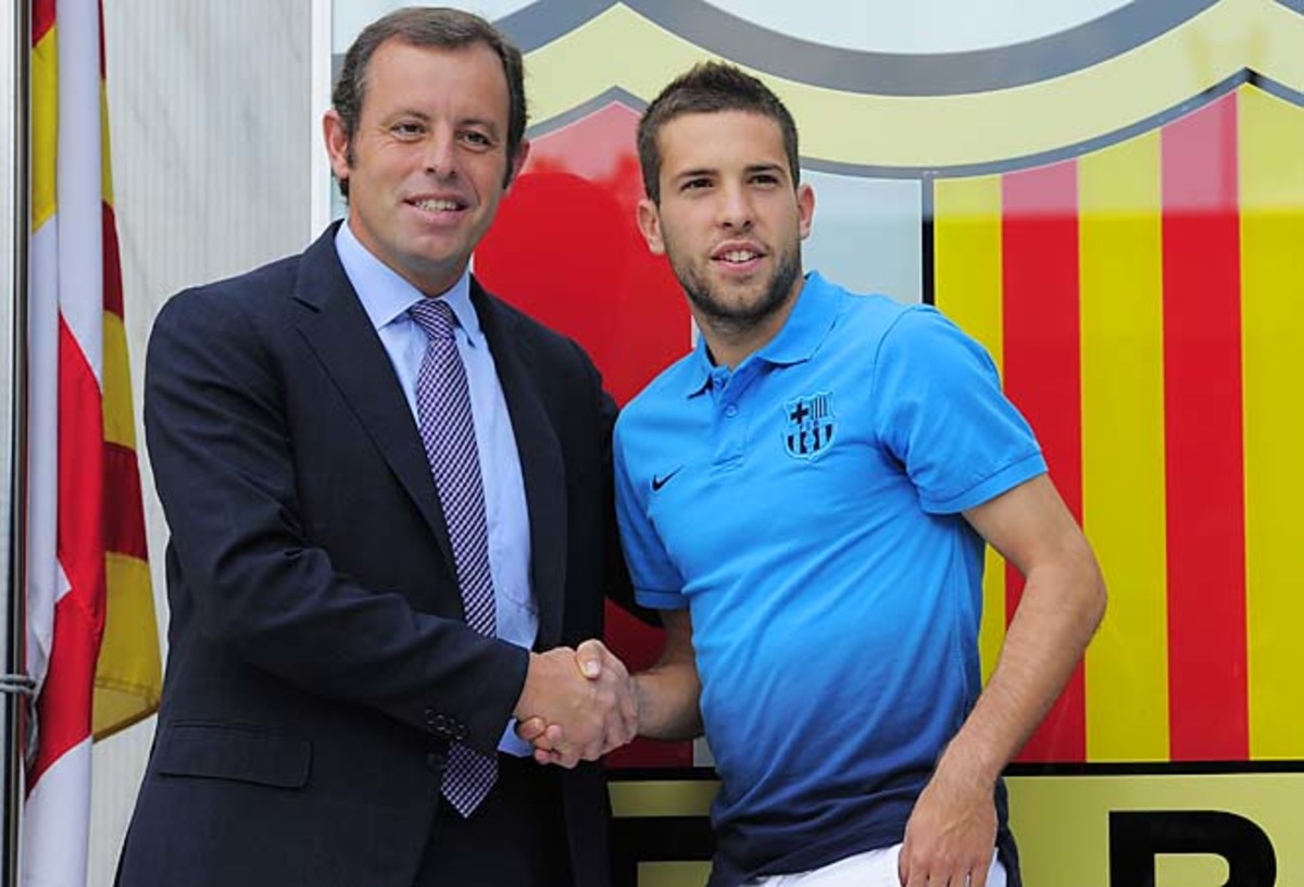 Sandro Rosell (left) shakes hands with Jordi Alba upon Alba joining Barcelona last year.