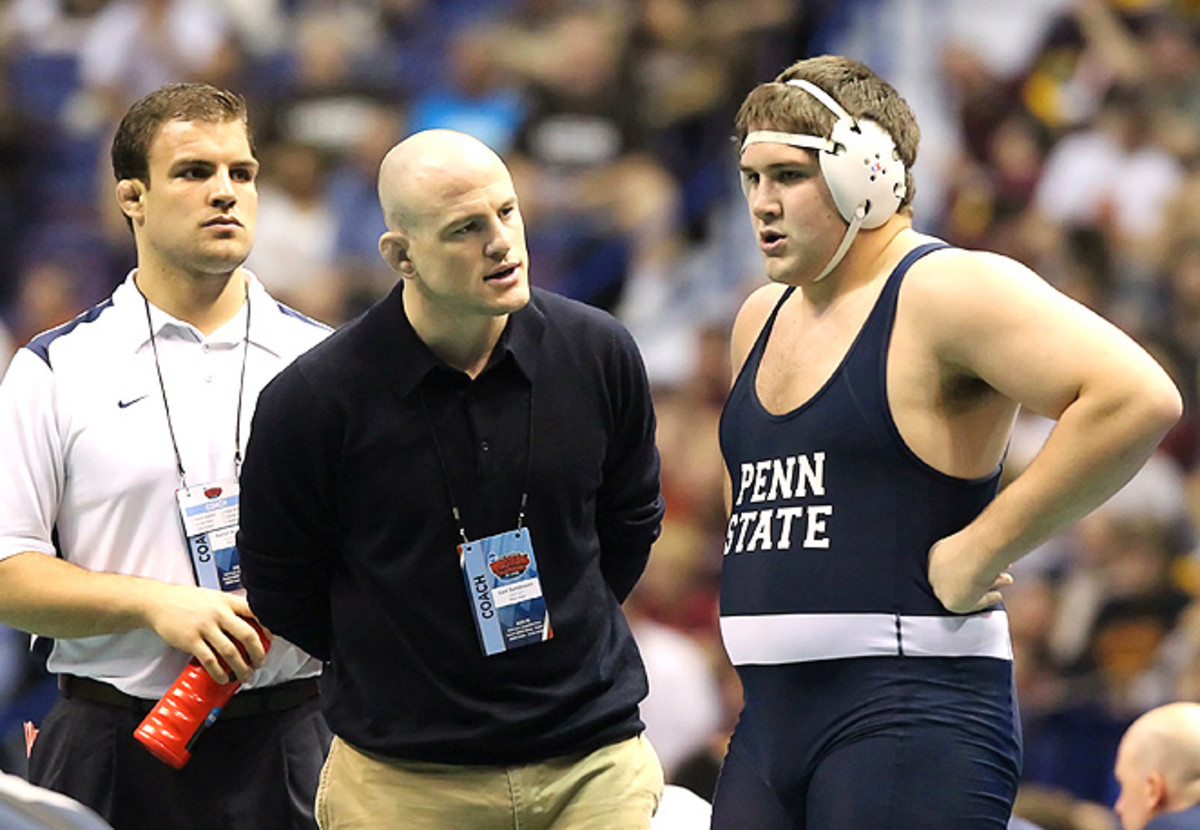 Cael Sanderson (center), 2004 Olympic gold medalist and current Penn State wrestling coach, knows NCAA wrestling will be hit hard by the Olympic wrestling's cut.