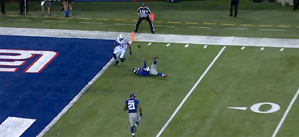 Aaron Ross should have a sure pick, but he falls down and loses the ball, which heads back up into the air.