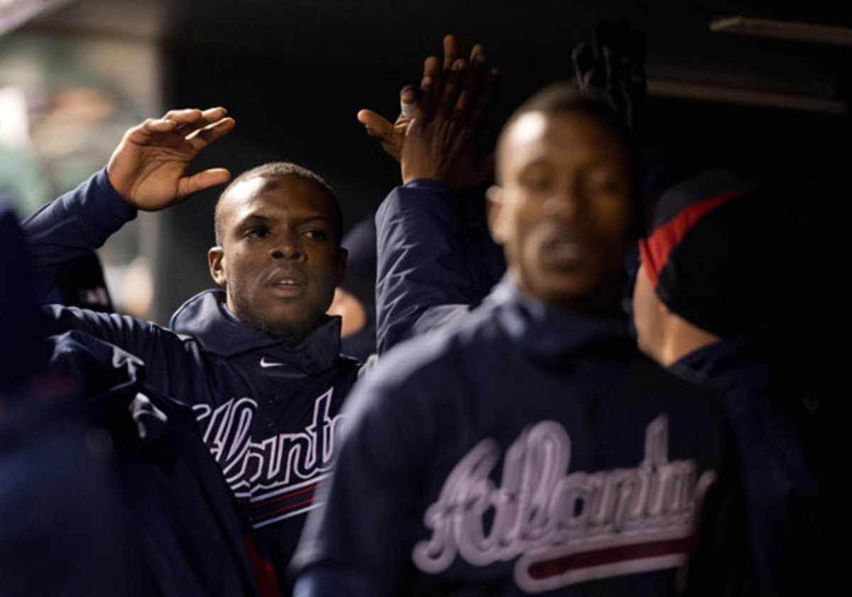 Justin Upton (back) followed up brother B.J.'s home run with one of his own in the X inning of the Braves' win against the Rockies on Tuesday. (Justin Edmonds/Getty Images)