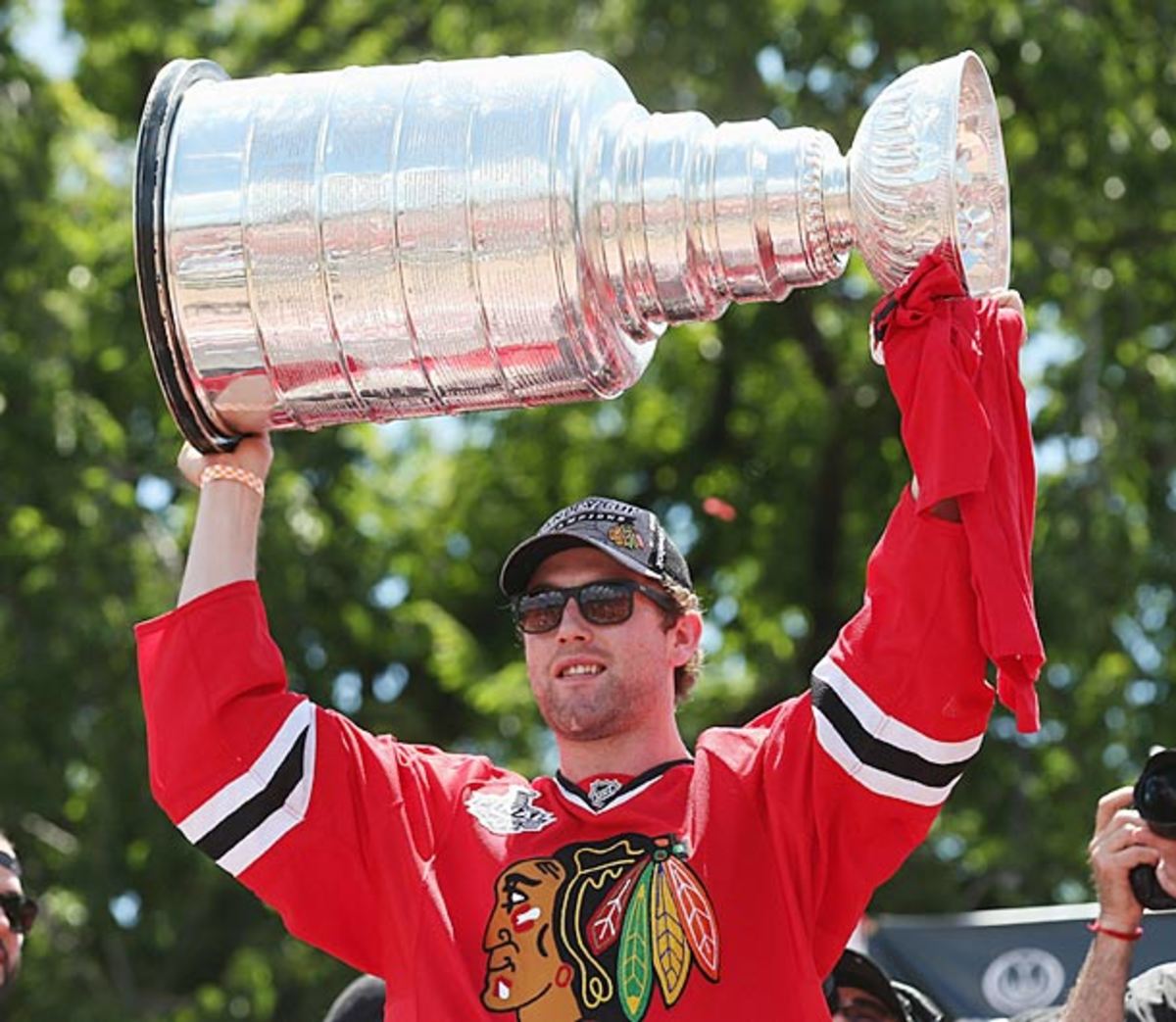 Former Chicago Blackhawks defenseman Ryan Stanton hoists the Stanley Cup.