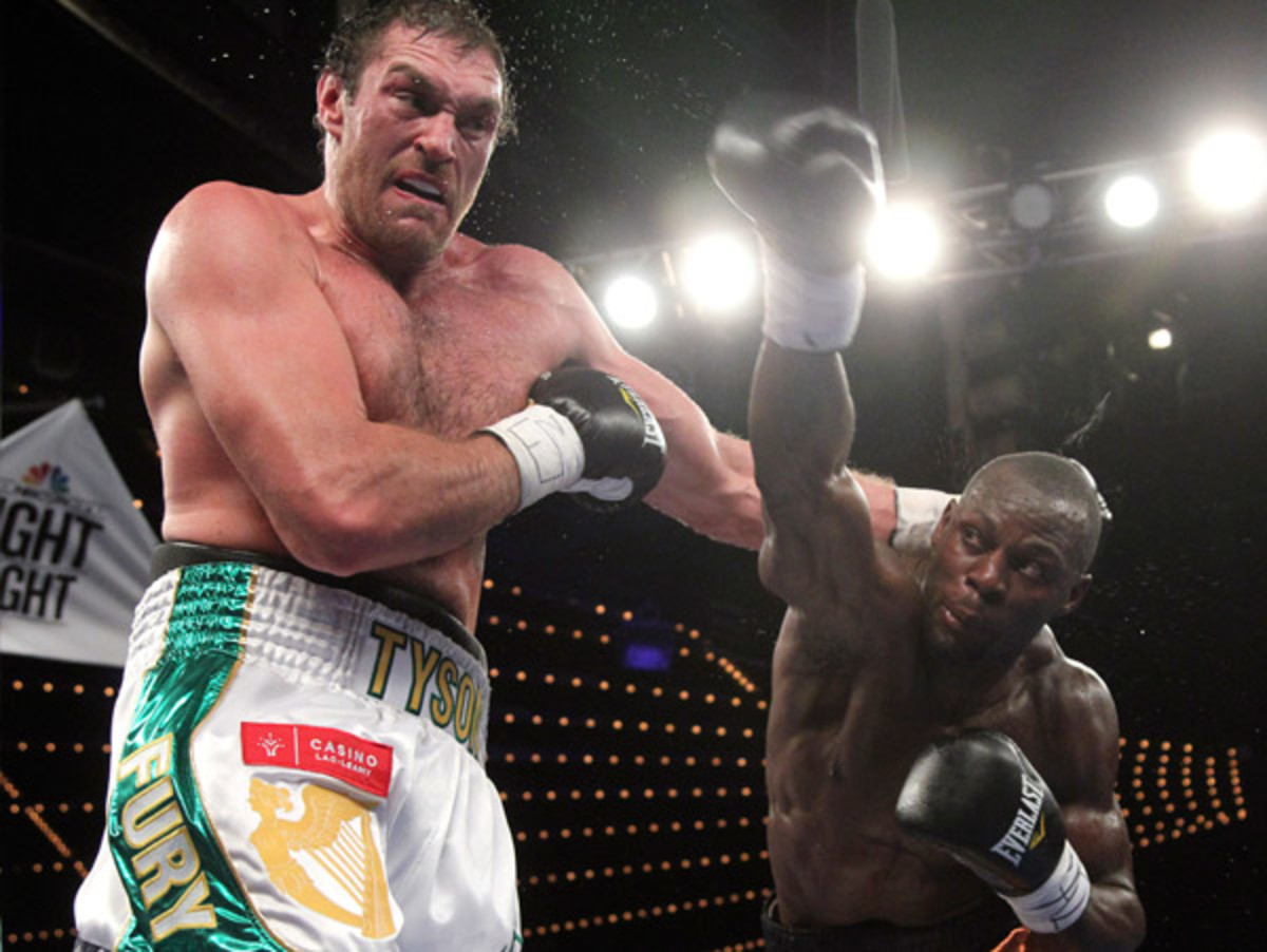 Tyson Fury (left) took a hard punch in the second round, but knocked out Steve Cunningham in the seventh. (Mary Altaffer/AP)