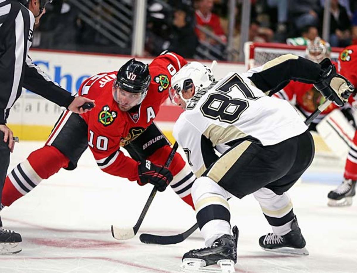 Patrick Sharp of the Chicago Blackhawks faces off against Sidney Crosby of the Pittsburgh Penguins