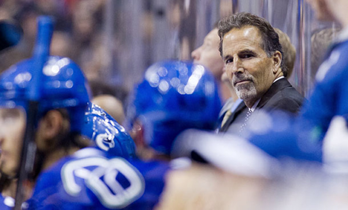 Coach John Tortorella watches game action from behind the Vancouver Canucks bench.