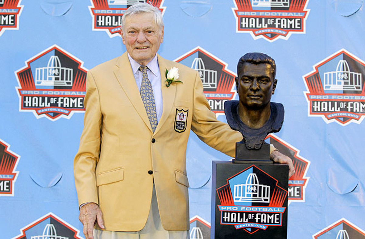 Jack Butler poses with a bust of himself during an induction ceremony at the Pro Football Hall of Fame in 2012.