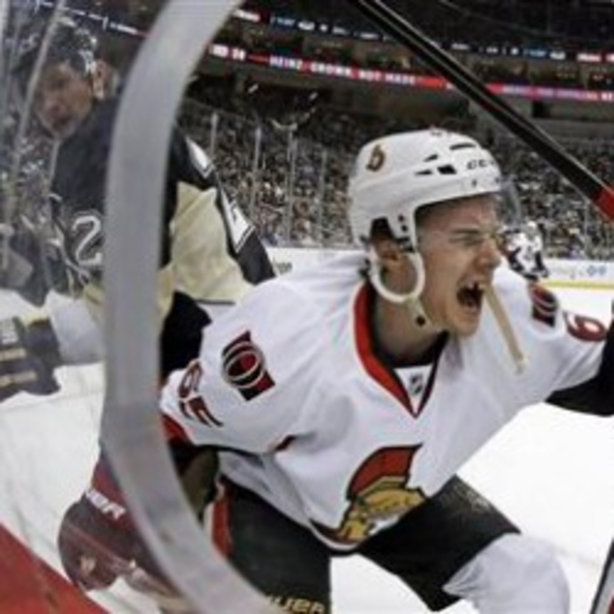Senators defenseman Erik Karlsson grimaces in pain after he is cut by a skate blade. (AP Photo/Gene J. Puskar)