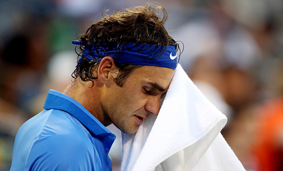 Roger Federer was knocked out with a loss in straight sets to the 19th-seeded Tommy Robredo.