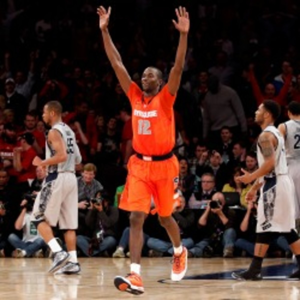 Baye Keita #12 of the Syracuse Orange celebrates after Syracuse won 58-55 in overtime against the Georgetown Hoyas.  (Photo by Chris Chambers/Getty Images)