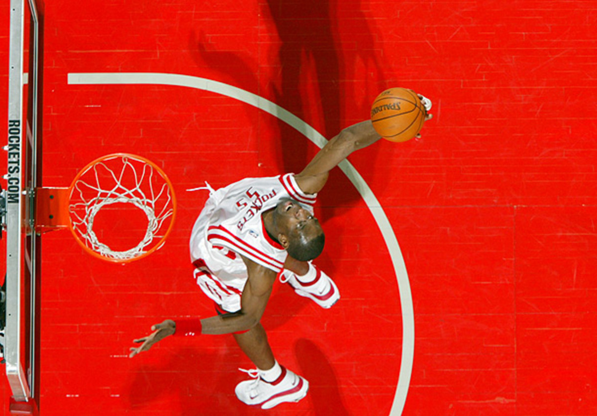 Dikembe Mutombo grabs a rebound