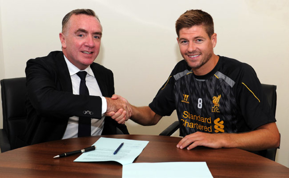 Steven Gerrard shakes the hand of Liverpool managing director Ian Ayre after signing a new contract.