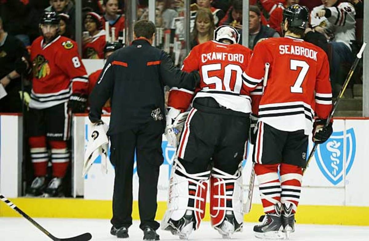 Chicago Blackhawks goalie Corey Crawford was helped off the ice after being injured in a game against the Florida Panthers.