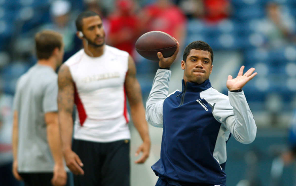 Colin Kaepernick and Russell Wilson have been asked to define their offenses this year, with varying results. (John Froschauer/AP)