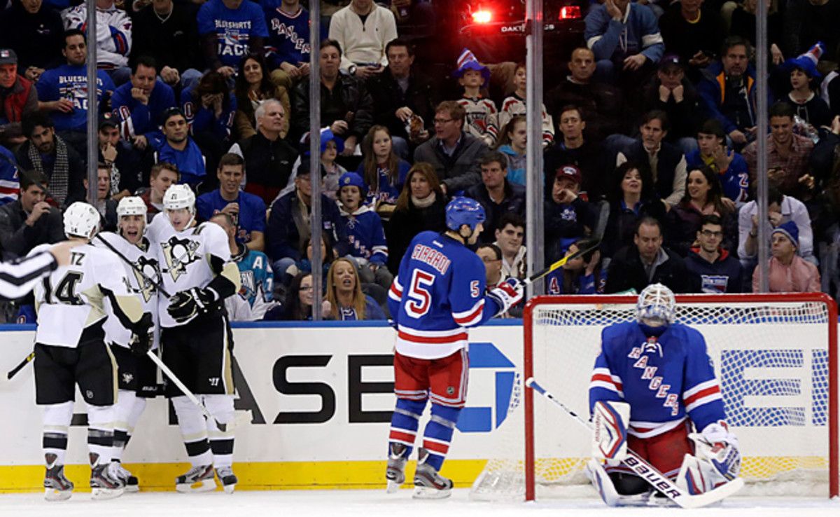 Rangers goalie Henrik Lundqvist reacts after giving up a goal to the Penguins' Pascal Dupuis (center of Penguins) in the second period.