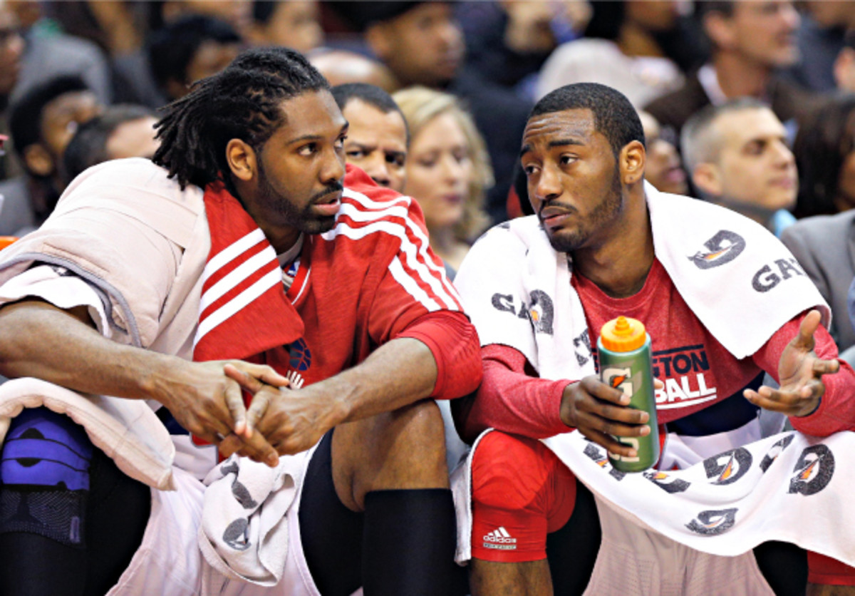 The Wizards have fallen to pieces whenever the starters -- like John Wall (right) and Nene -- have checked out of the game. (Rob Carr/Getty Images)