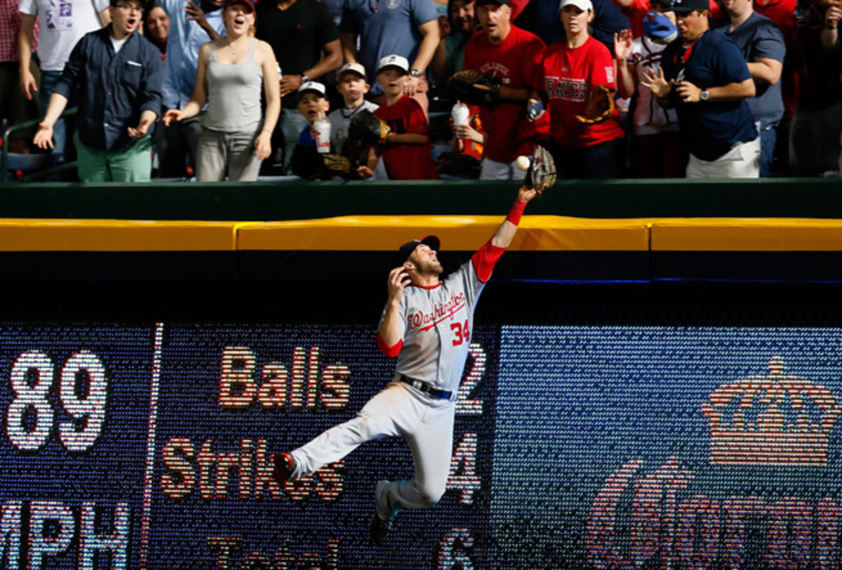Bryce Harper initially bruised his left shoulder trying to make a catch in Tuesday's game against Atlanta.