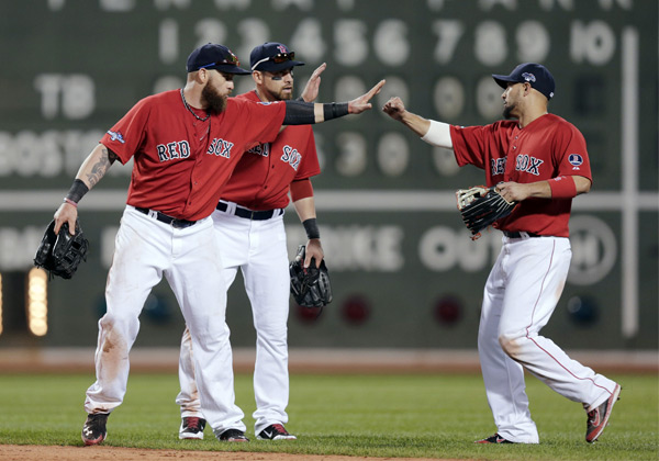 Jonny Gomes (left), Jacoby Elsbury and Shane Victorino (right) combined for 5 RBIs in the win. (Charles Krupa/AP)