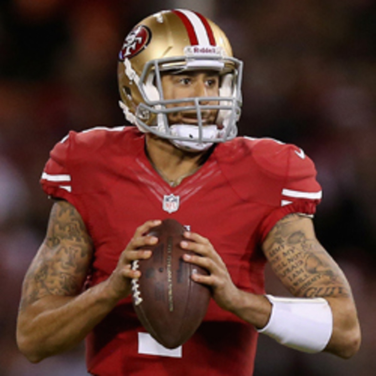 Colin Kaepernick's tattoos include Bible verses. (Ezra Shaw/Getty Images)