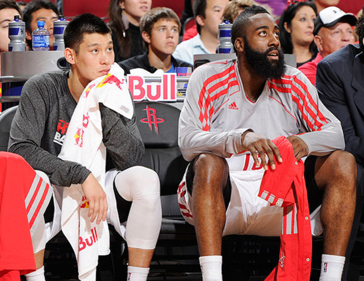 Lin and James Harden watch the action from the Rockets bench. (Bill Baptist/Getty Images)