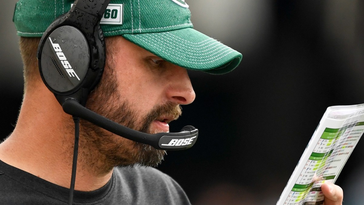 Jets head coach Adam Gase looks at his playbook during a game