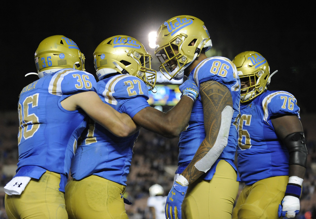 November 2, 2019; Pasadena, CA, USA; UCLA Bruins running back Joshua Kelley (27) celebrates his touchdown scored with tight end Devin Asiasi (86) wide receiver Ethan Fernea (36) and offensive lineman Christaphany Murray (76) during the second half at the Rose Bowl.