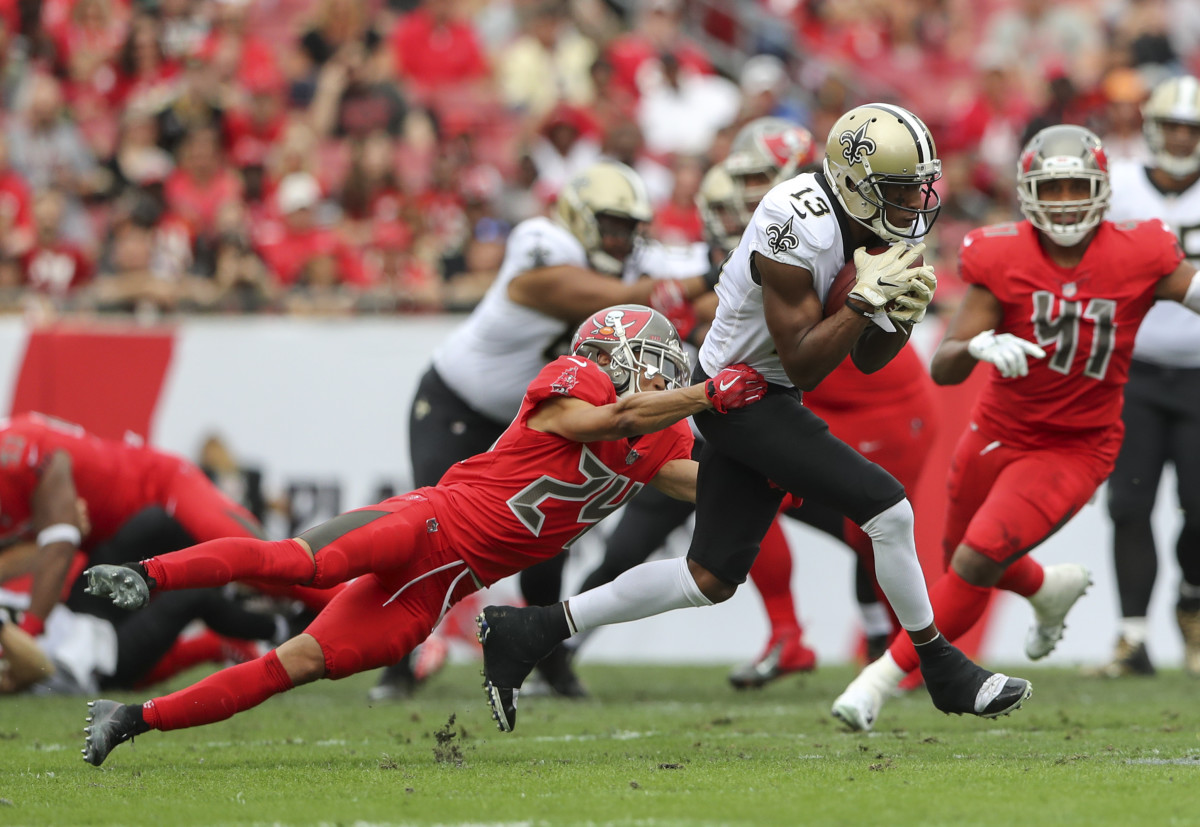 Dec 9, 2018; Tampa, FL, USA; New Orleans Saints wide receiver Michael Thomas (13) runs with the ball as Tampa Bay Buccaneers cornerback Brent Grimes (24) defends during the first half at Raymond James Stadium. Mandatory Credit: Kevin Jairaj-USA TODAY Sports