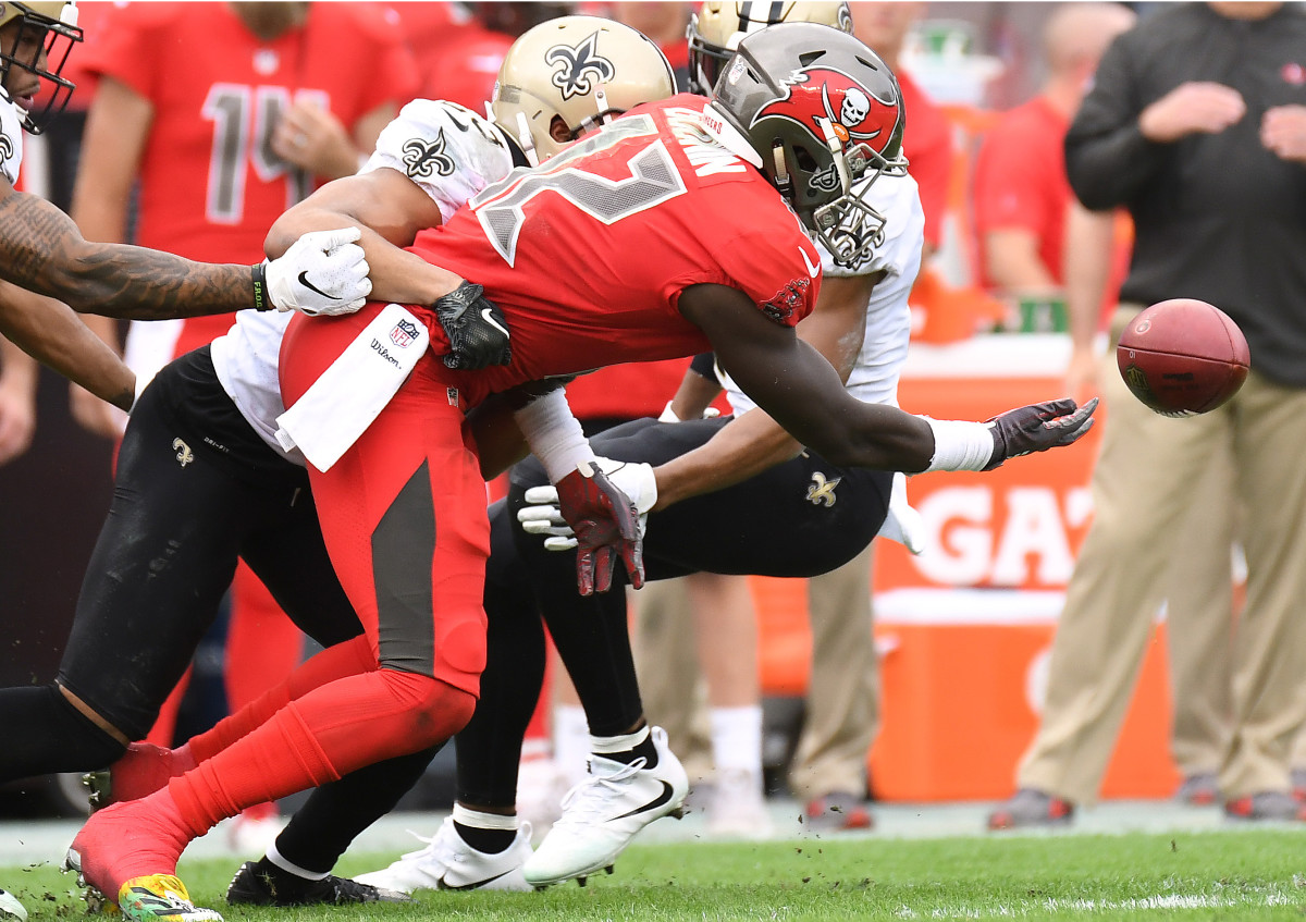 Dec 9, 2018; Tampa, FL, USA; New Orleans Saints defensive back Marcus Williams (43) knocks the ball loose from Tampa Bay Buccaneers wide receiver Chris Goodwin (12) during the first half at Raymond James Stadium. Mandatory Credit: Jonathan Dyer-USA TODAY Sports