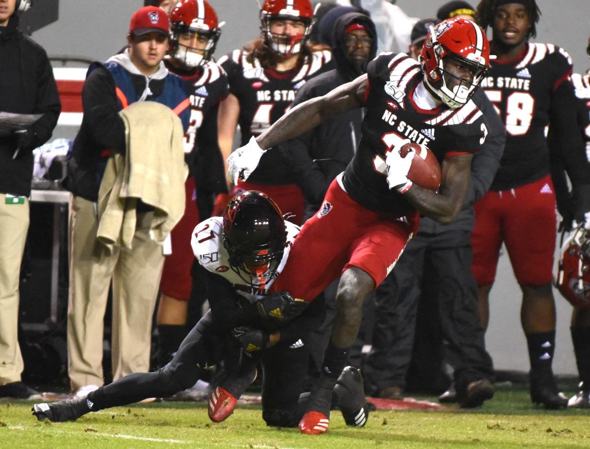 Emeka Emezie tries to break free trom the tackle of Louisville's Anthony Johnson